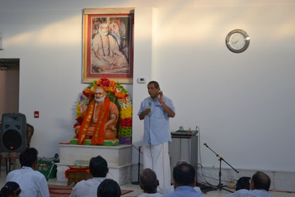 Dr. Gowrishankar addressing Devotees